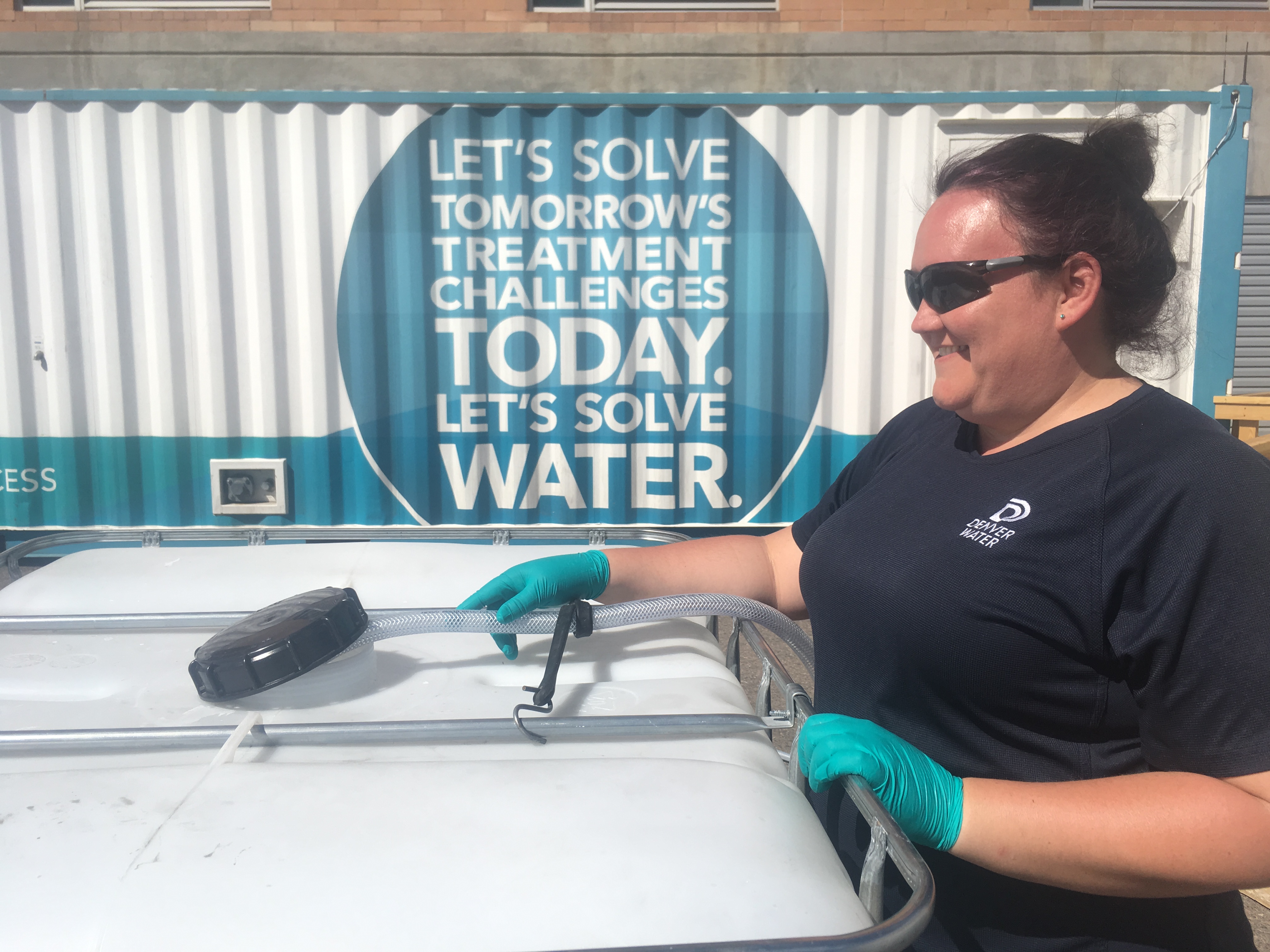 Shana Colcleasure, water treatment technician, Denver Water, fills a container with purified water that will be delivered to Declaration Brewery.