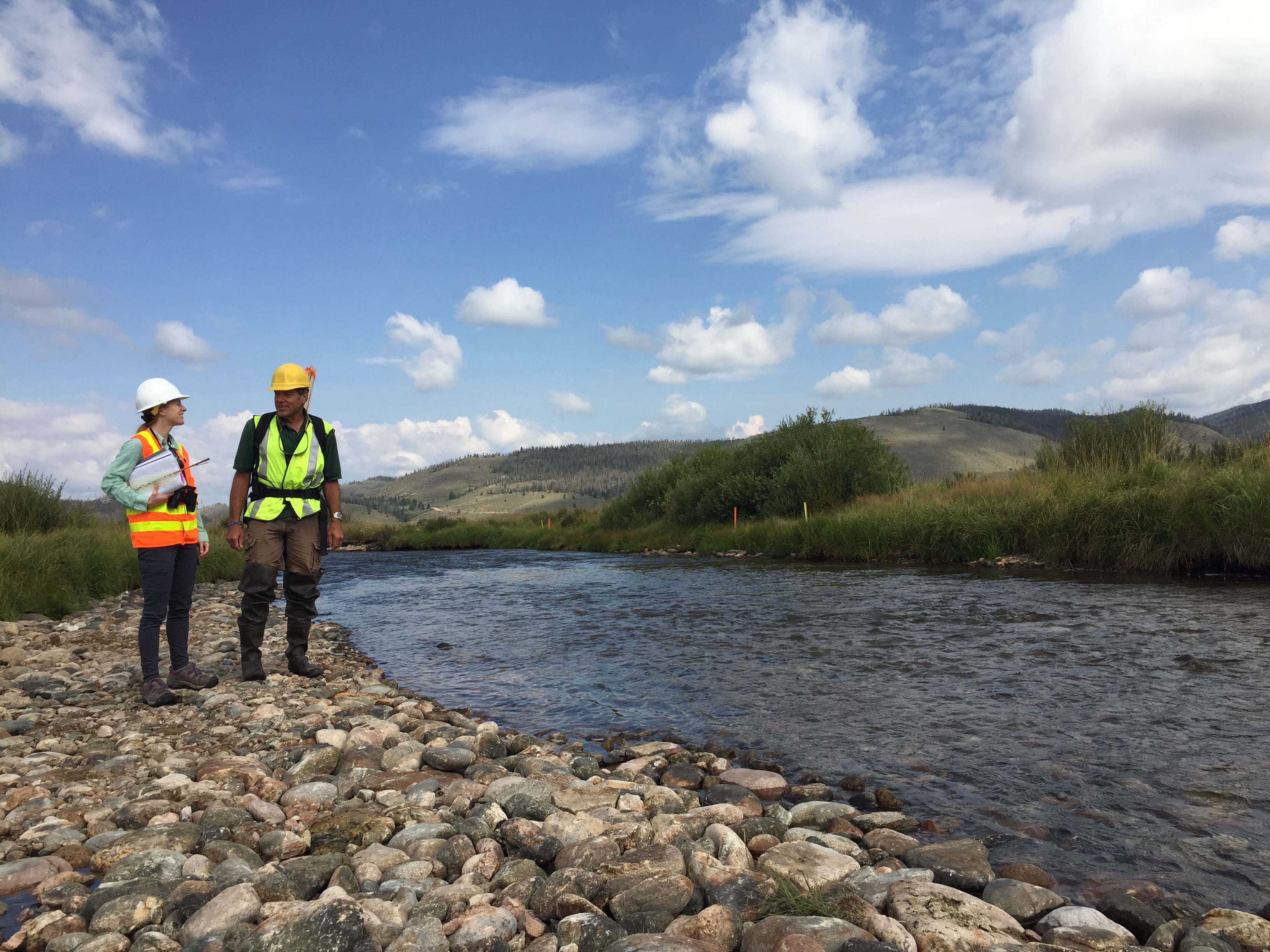 Jessica Alexander, Denver Water environmental scientist (left), evaluates river improvements with Kirk Klancke, president of the Colorado River Headwaters Chapter of Trout Unlimited.