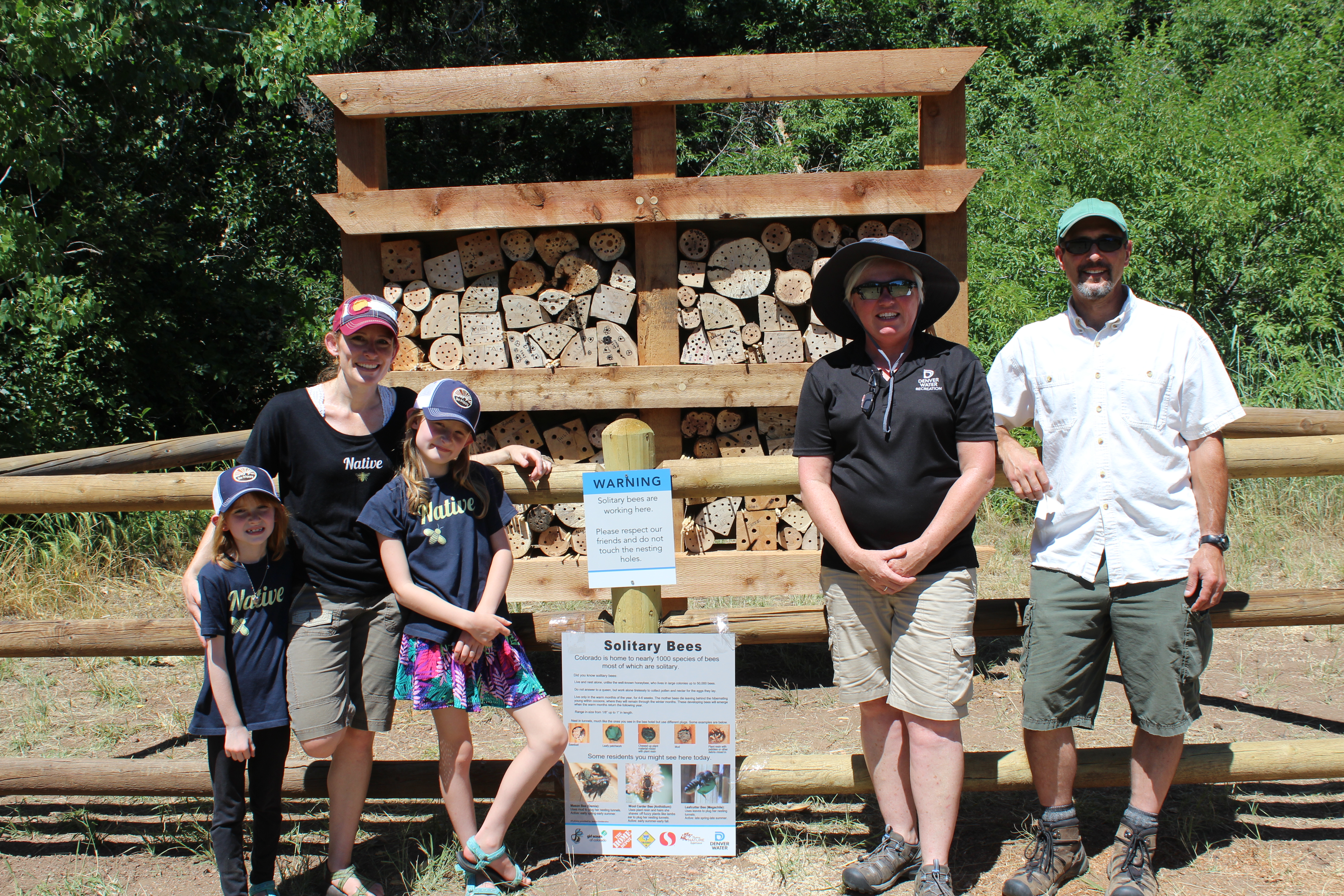 Jessica Goldstrohm from The Bees Waggle with her two daughters, Terri Doolittle, Waterton Canyon ranger and Philip Cuka, bee hotel creator (pictured left to right) stand in front of Waterton Canyon's first bee hotel.