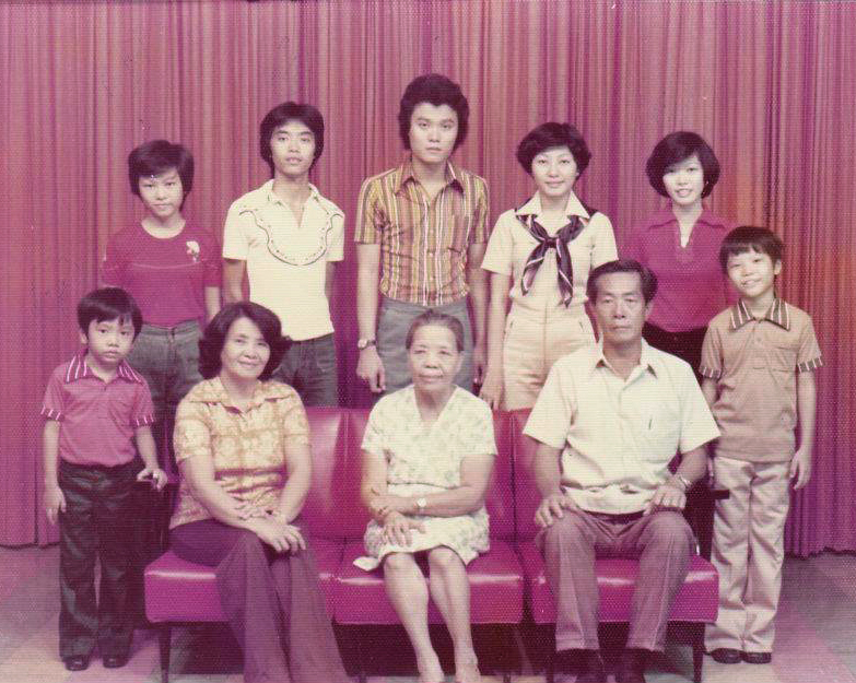Ama (seated left) with her mother (seated center), husband (seated right) and seven children in Cebu City, Philippines, 1976. Photo credit: Jason Kearns.