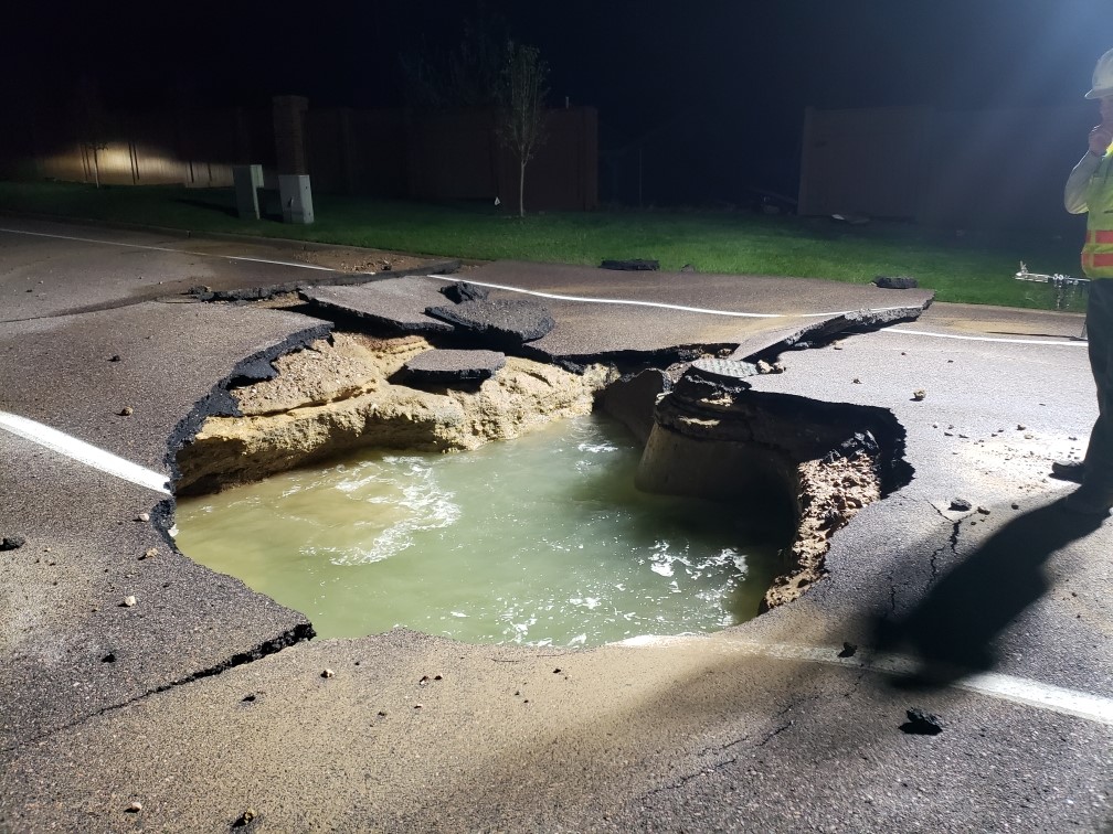 The water main break left a large hole in the street. Photo credit: Denver Water.