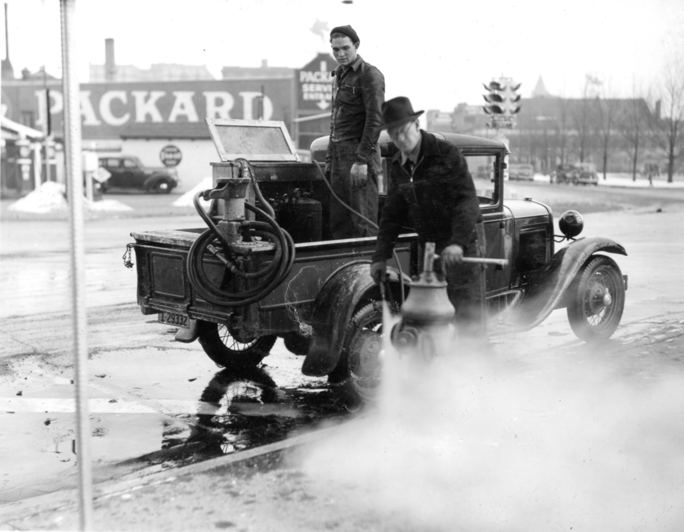 Denver Water employees, Raymond Hebenstreit and Ernest Shears, thaw a fire hydrant with steam in 1940.