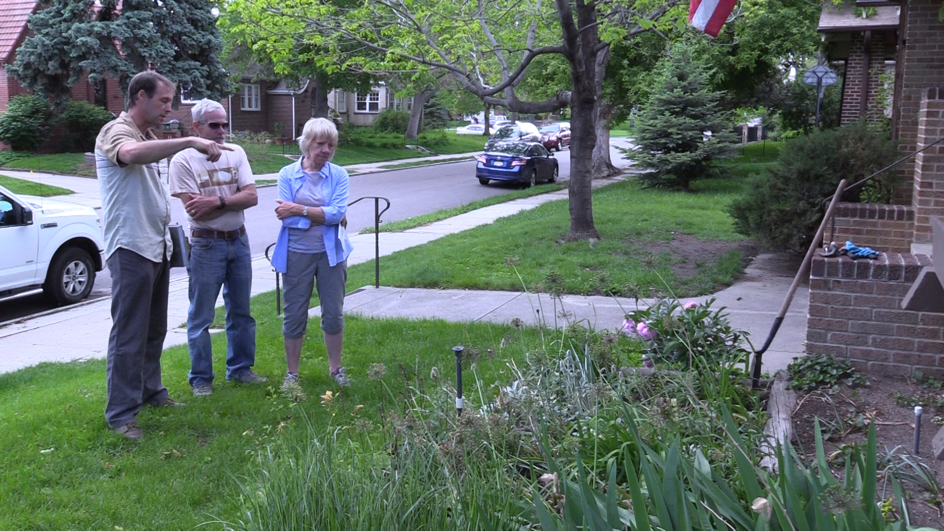 Landscape designer Curtis Manning (left), discusses landscape options in the front yard with Kim Hartsen (middle), and April Montgomery (right).