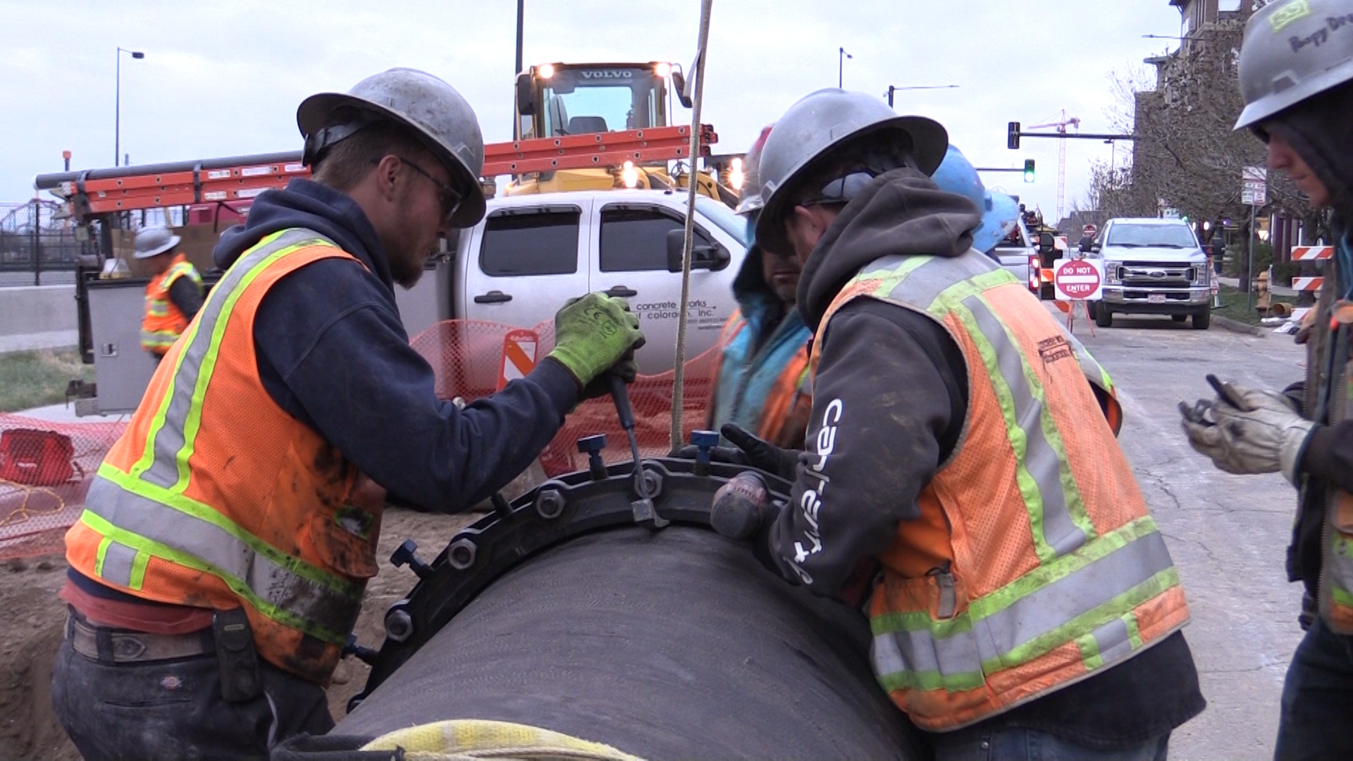 Crews from Concrete Works of Colorado prepare a pipe for installation in Denver's Highland neighborhood in April 2018.