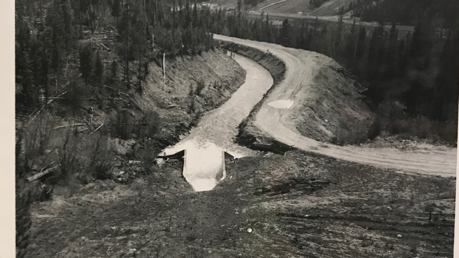 Ranch Creek Canal flowing in 1956. The original canal was dug out of the side of a hill and not covered. Photo credit: Denver Water. 