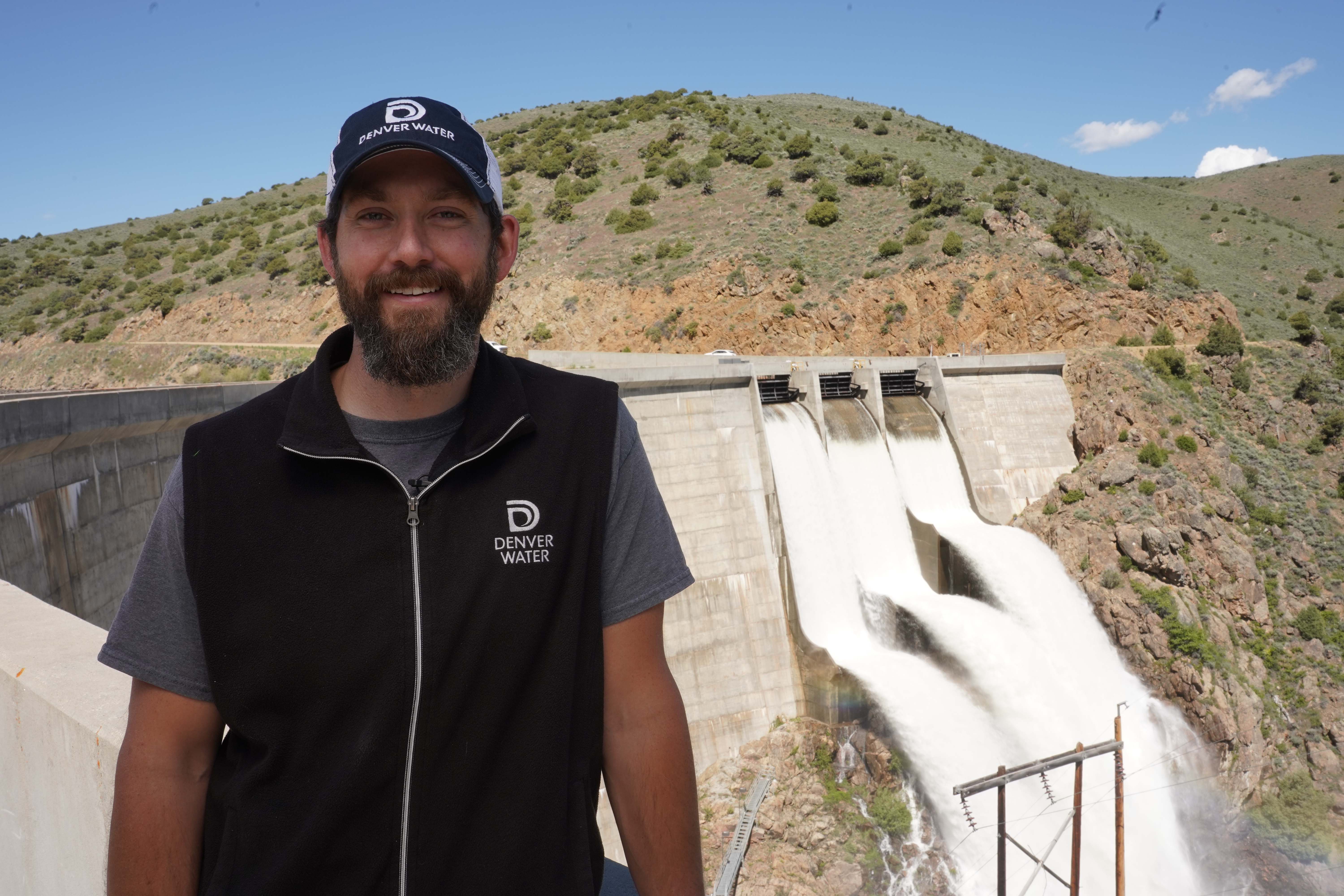 This photo shows a Denver Water worker standing in front of the Williams Fork Dam.