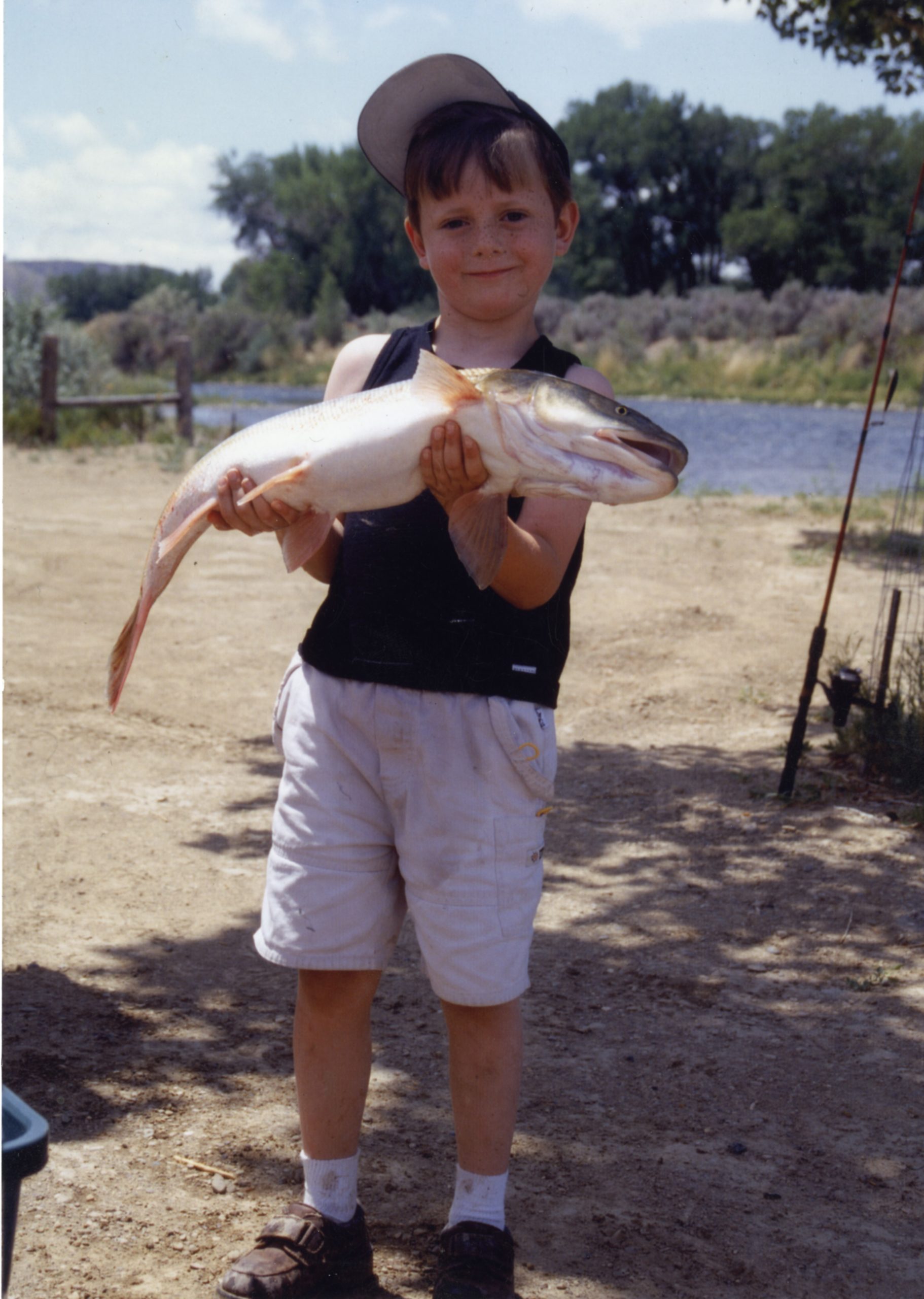 The author's son, about five years old here, holds a Colorado pikeminnow, once the King of the Colorado River.