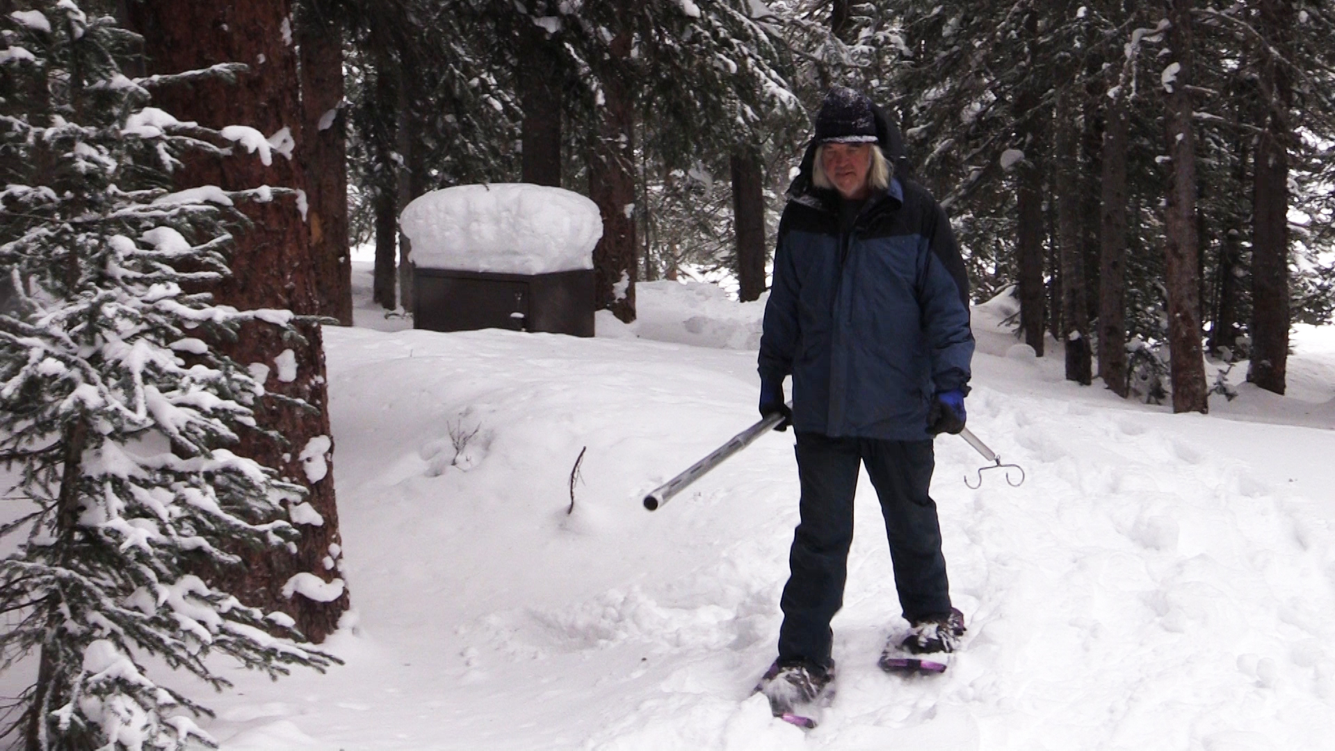 Per Olsson snowshoes through the woods to access snow-measuring sites.