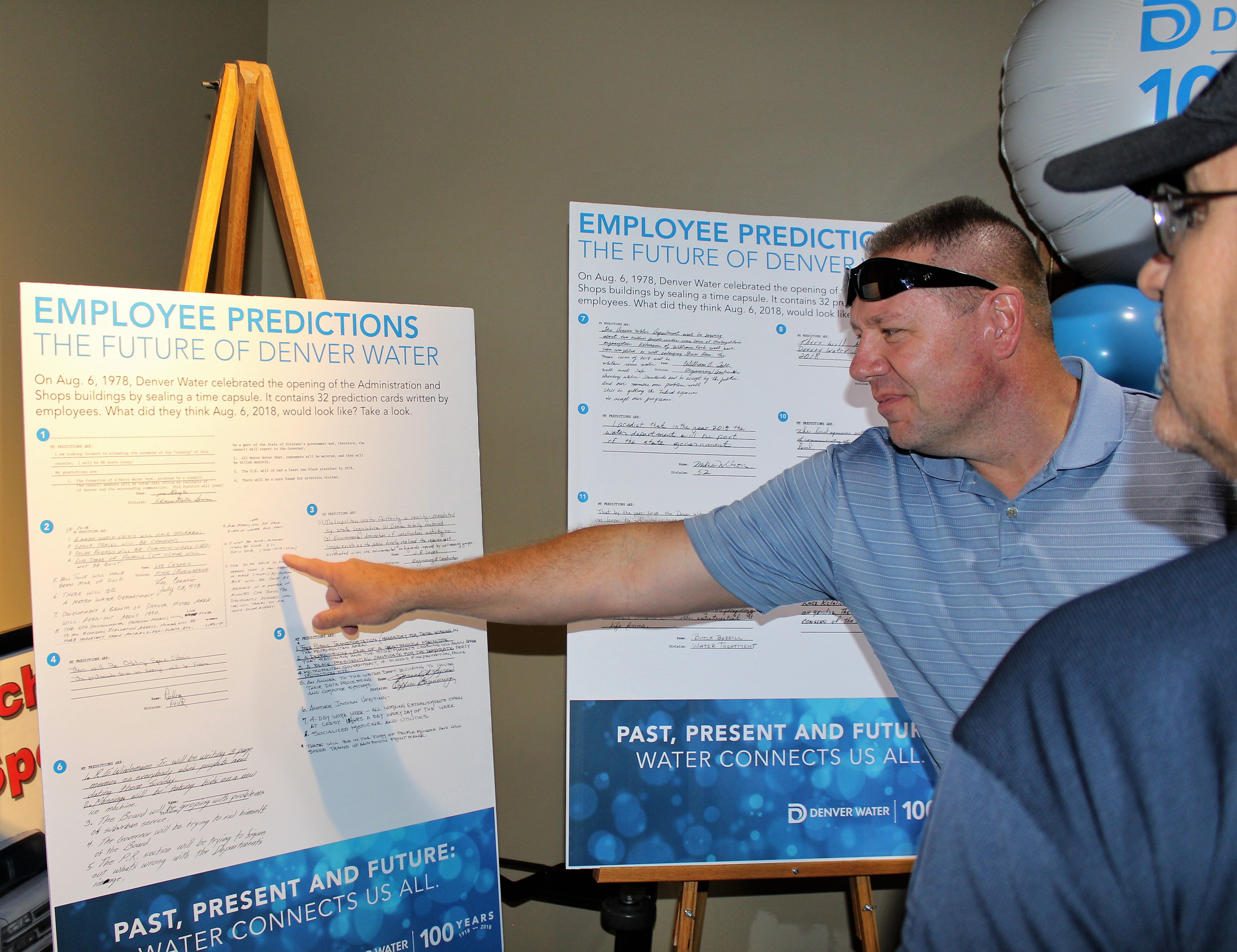Meter shop foreman, Bryan Campbell, reads some of the employee predictions from 40 years ago after they were unveiled from the time capsule.