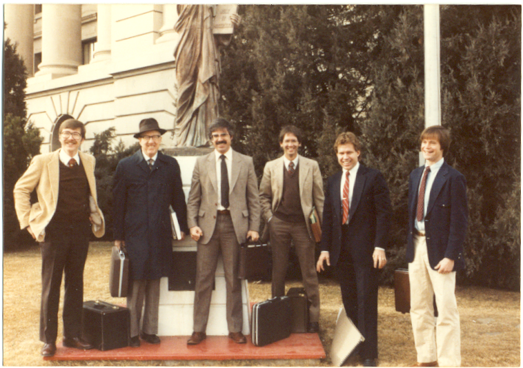 In earlier days, Funk (third from the right poses with (from left)  Mike Walker, Wayne Williams, Greg Campbell, Mark Soutor and Bill Bates in front of the Weld County District Court in Greeley (Water Division 1 Water Court). Photo credit: Denver Water.

