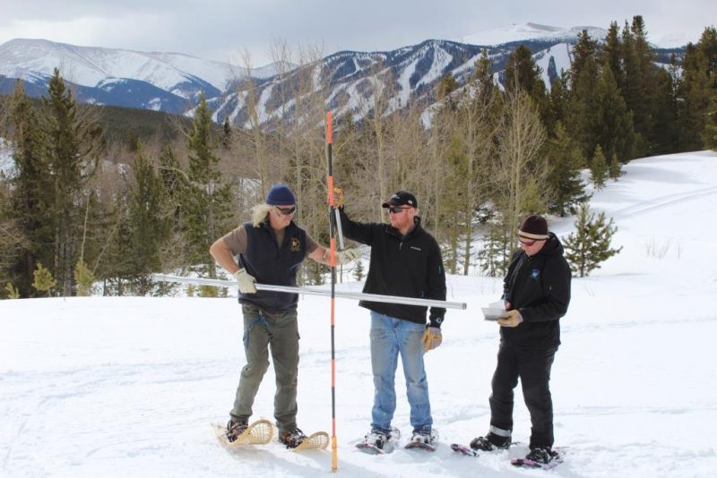 employees stationed in Winter Park take measurements of snowpack
