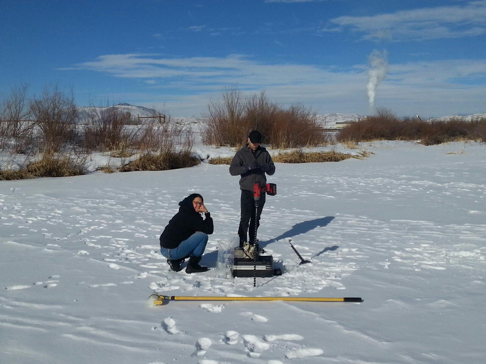 Water quality investigators gather samples all year long. Aubrey Miller (left) and James Berrier, drill through two feet of ice on the Colorado River near Kremlin to gather samples.