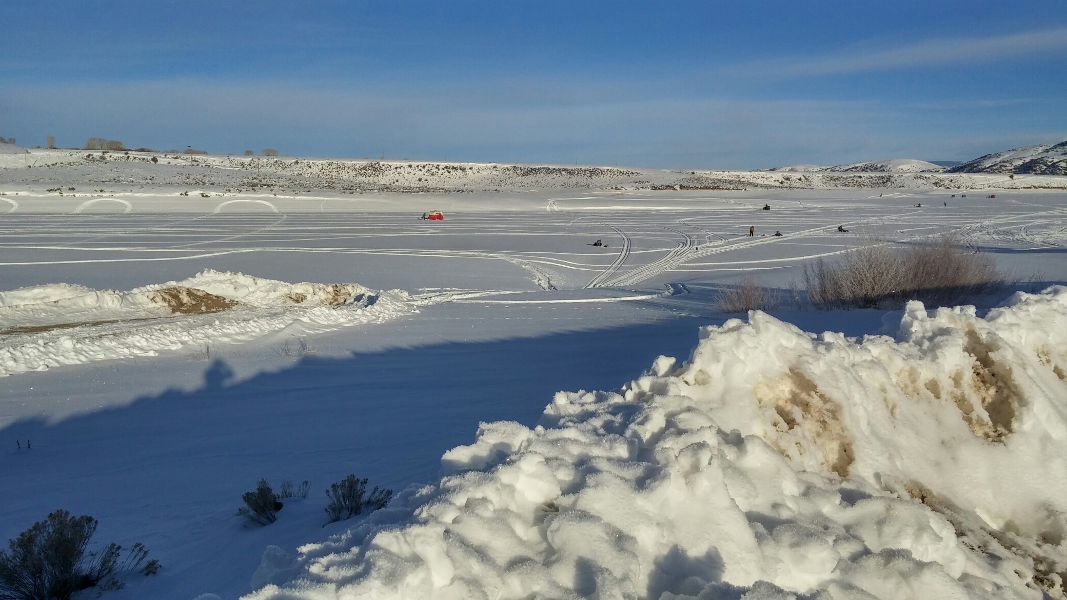 The frozen Williams Fork Reservoir starts to fill up with ice fishermen at the beginning of a daylong ice fishing tournament.